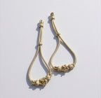 Sujeta mangas caftán dorado